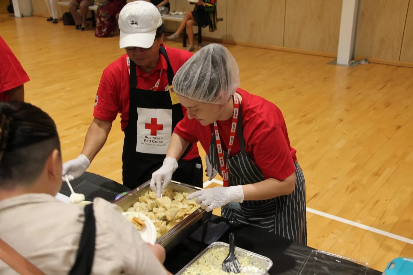 Australian Red Cross volunteers helping serve Ukrainian dishes